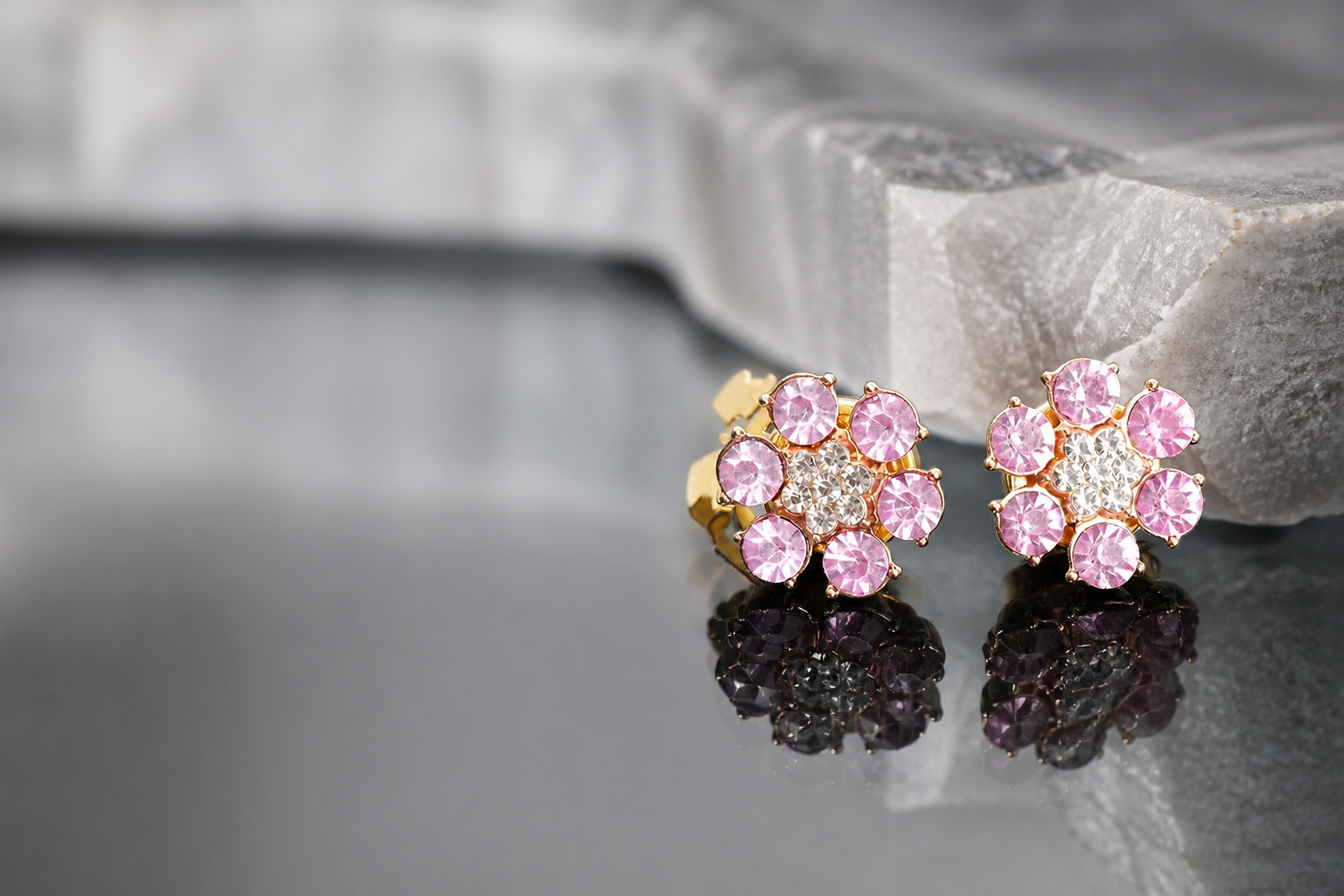 Pink crystal button covers on reflective stone